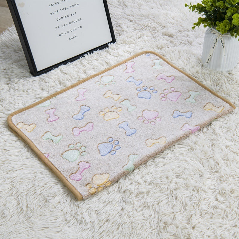 Decorative mat with colorful paw and bone patterns on a white surface.
