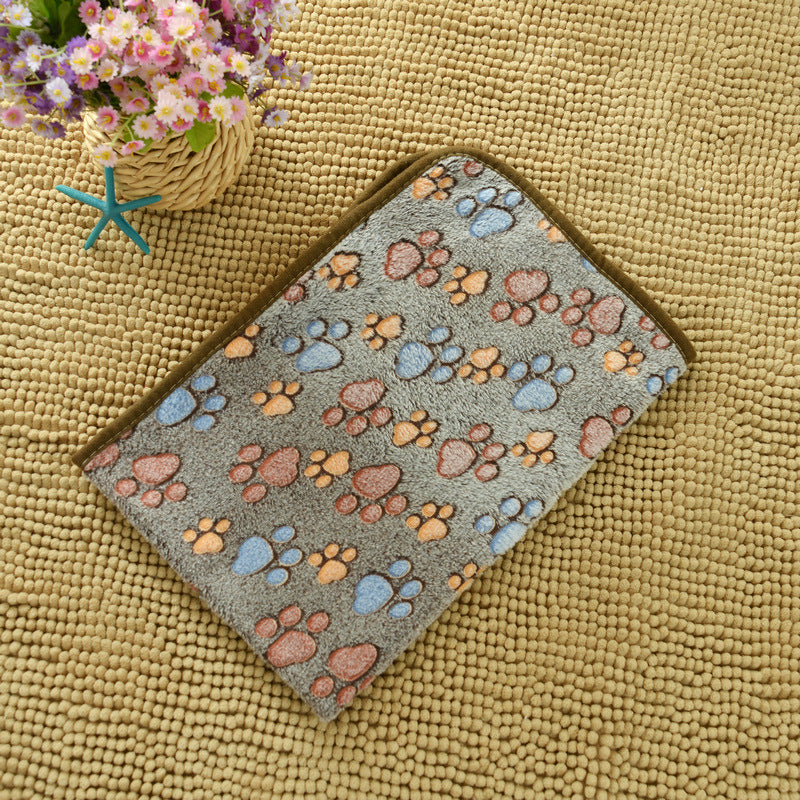 Doormat with paw print pattern on a textured surface