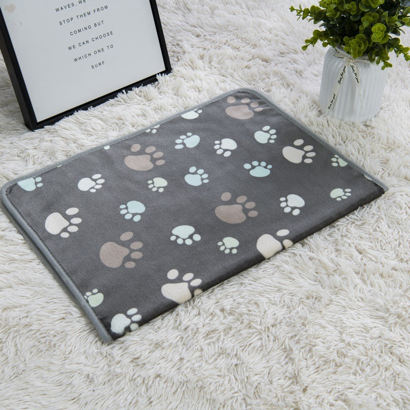 Gray mat with paw print pattern on a white carpet