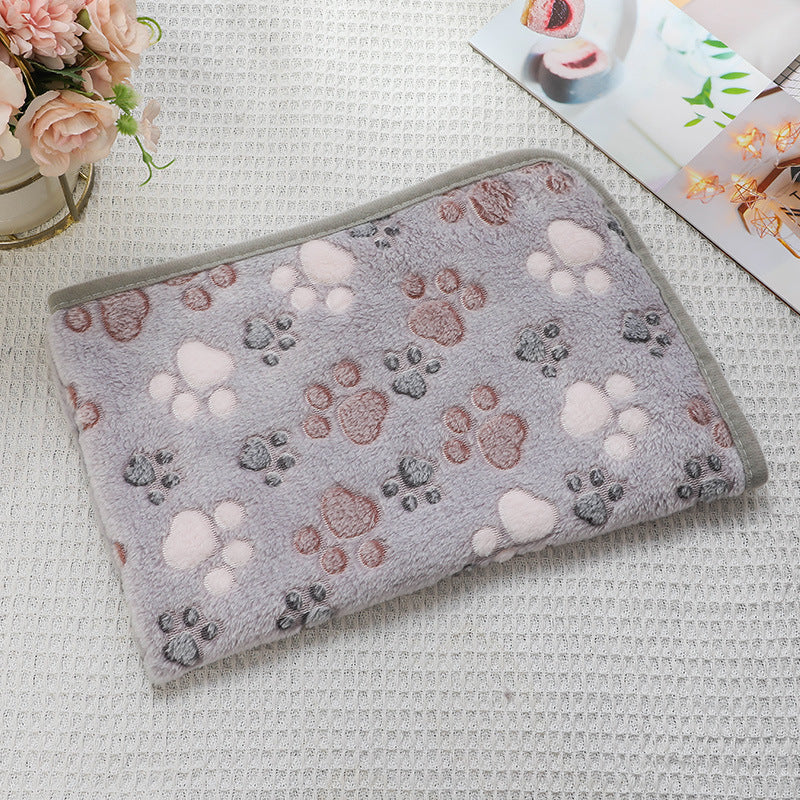 Gray pet blanket with paw print pattern on a textured surface