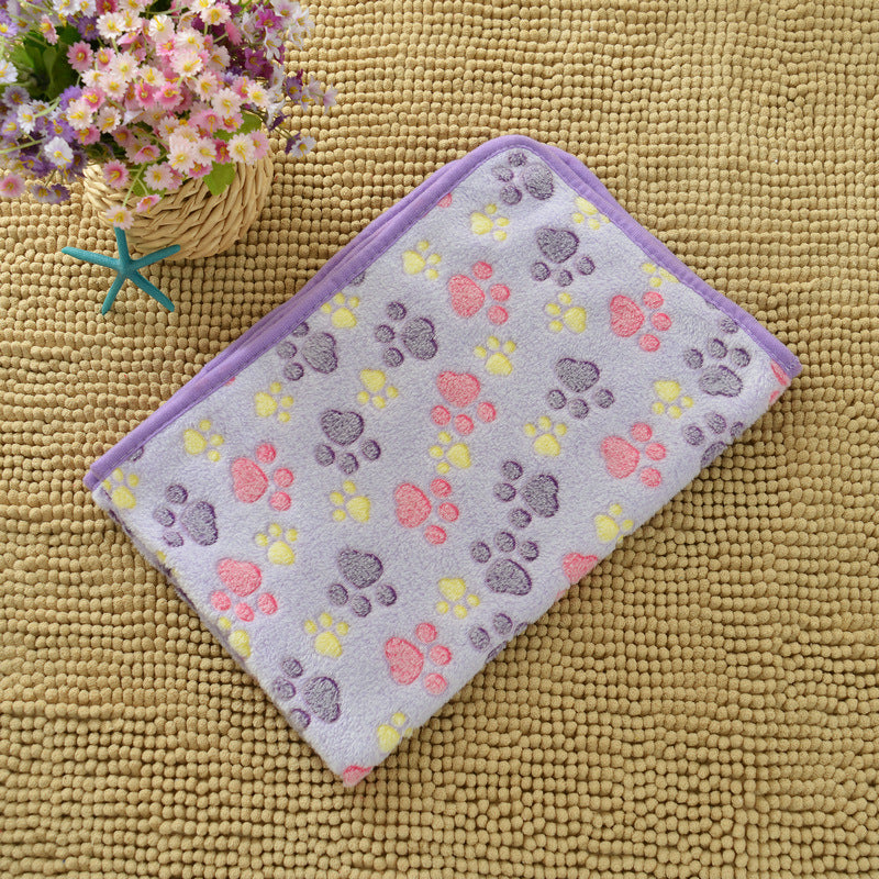Pet mat with paw print pattern on a textured surface