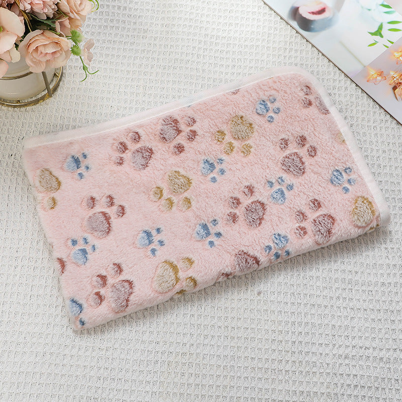 Pink pillow with paw print pattern on a textured surface
