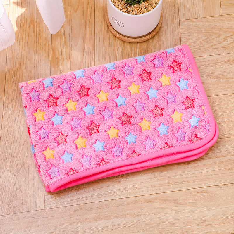 Pink towel with star patterns on a wooden floor