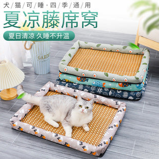 Cat lying on a patterned pet bed with additional cooling mats in the background.